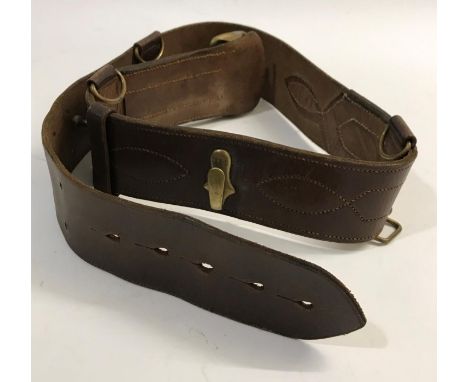 A SAM BROWNE BELT AND OTHER ITEMS. A British Army Officers Sam Browne belt, a cartridge belt and shoulder bag.