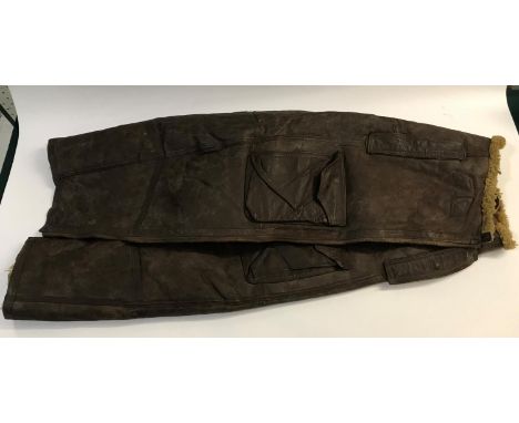A PAIR OF SECOND WORLD WAR 'IRVINE' FLYING TROUSERS. A pair of leather and fur lined flying over trousers and braces, with la