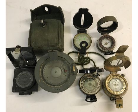 A MEDIUM LANDING COMPASS AND OTHERS. A Medium Landing Compass No. 1122KHI/54, two second world war compasses and three others