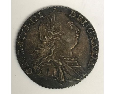 A GEORGE III SHILLING. A George III Shilling dated 1787, old laureate and draped bust, r, reverse with Semee of hearts.