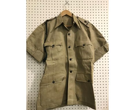 UNIFORM OF THE KING'S AFRICAN RIFLES. A waxed cotton short sleeved jacket with shoulder initials 'KAR' for the King's African