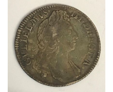 A WILLIAM III SHILLING. A William III Shilling dated 1697, first draped bust r, reverse with crowned cruciform shields and pl