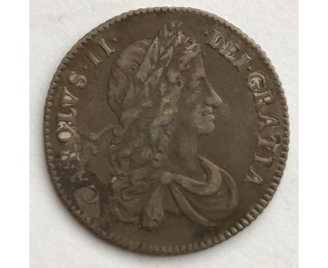 A CHARLES II SHILLING. A Charles II Shilling dated 1663, first draped bust r, regular die axis, interlinked Cs to angles.