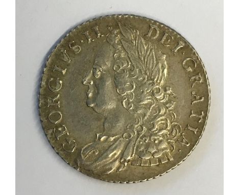 A GEORGE II SHILLING. A George II Shilling dated 1758, old laureate draped bust r, plain angles.