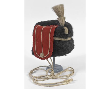 A HUSSARS BUSBY AND THREE FURTHER ITEMS. A Hussars Busby with red side flash and stepped plume with long braided attachment, 