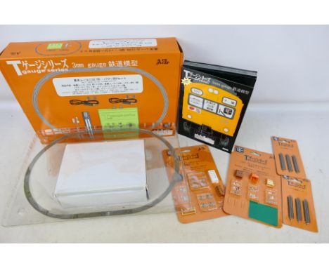 Ace Cap - A boxed Japanese T gauge track set #106006 and accessories. Includes building sets 'A' & 'B' Train Pack #008 East J