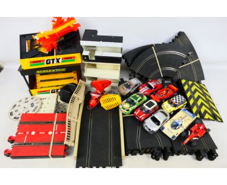 Scalextric - A collection of Scalextric items including track, trackside buildings, barriers, controllers and 9 x cars. The i