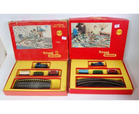 A Triang RS24 train set containing blue 0-4-0 tank engine no. 7 "Nellie" 3 wagons super 4 track oval (G-BG) and a similar wit