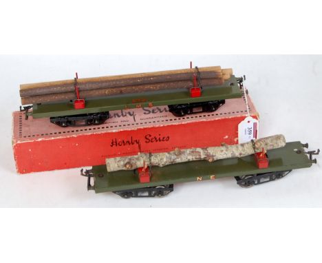 Two Hornby No. 2 lumber wagons: 1925-30 LMS olive green base, red bolsters, LMS both sides, 5 poles load, might be original (