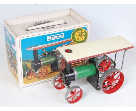 A Mamod TE1A live steam traction engine of usual specification with canopy, steering rod, burner, scuttle, and funnel, housed
