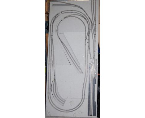 A professionally made wooden based N gauge layout suitable for finishing, fitted with control unit and a large number of trac