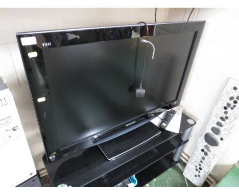 PANASONIC VIERA 37 INCH LCD TELEVISION ATTACHED TO A THREE TIER BLACK GLASS TV STAND, WITH REMOTE CONTROL AND MANUAL.