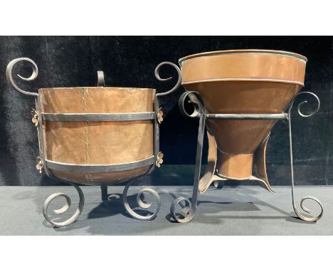 An Arts and Crafts copper and wrought iron log bin or planter, cylindrical copper bucket supported by wrought iron frame, eac