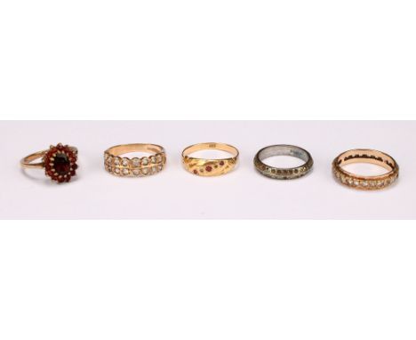 A 9ct gold garnet flowerhead cluster ring, size L, 2.9g; a 9ct gold eternity ring, set with clear stones, a 9ct gold ruby chi