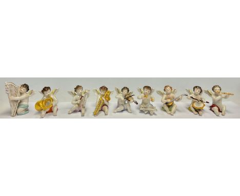 A Dresden porcelain miniature angelic band group, each cherub with a musical instrument, comprising, harpist, glockenspiel, l