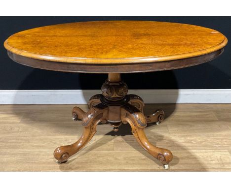A Victorian walnut centre table, quarter-veneered tilting top, cabriole legs, ceramic casters, 74cm high, 122cm long, 88cm wi