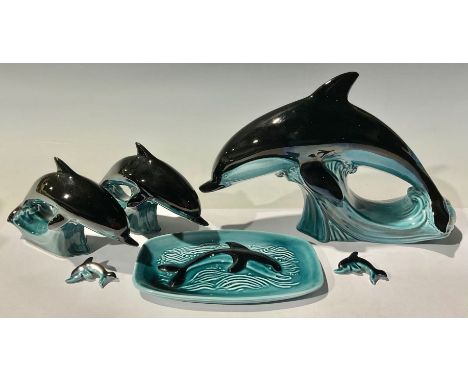 Studio Pottery - a graduated set of three Poole Pottery dolphins, the largest 19cm high, 28cm wide; a pair of conforming broo