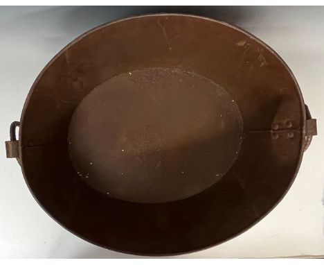 An oval metal iron ring handled oval bath tub planter, 57cm wide over handles 