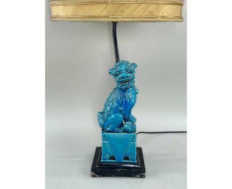 CHINESE BUDDHISTIC LION PORCELAIN TABLE LAMP, turquoise glazed, one paw resting on a playful cub, seated on a draped plinth, 