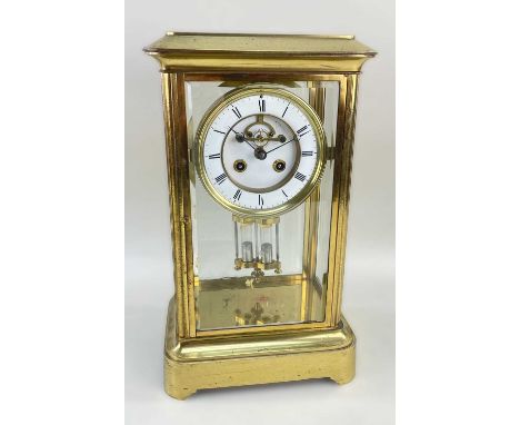 19TH CENTURY FRENCH GILT BRASS MANTEL CLOCK, in a glazed case with white enamel dial and Roman chapter ring, visible brocot 8