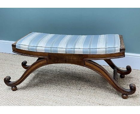19TH CENTURY MAHOGANY WINDOW STOOL, channel moulded scroll supports joined by ring-turned stretchers, ball feet, Regency stri