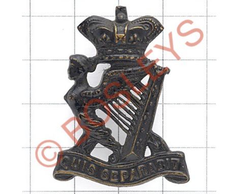 Royal Irish Rifles Victorian field service cap badge circa 1896-1901.Die-stamped blackened brass crowned Maid of Erin Harp on