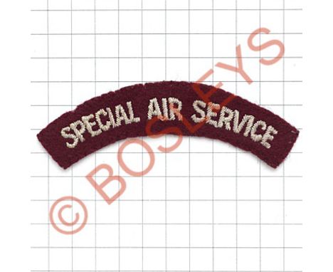 SPECIAL AIR SERVICE cloth shoulder title.Smaller light blue embroidered on maroon.   Removed from uniform.  GC 