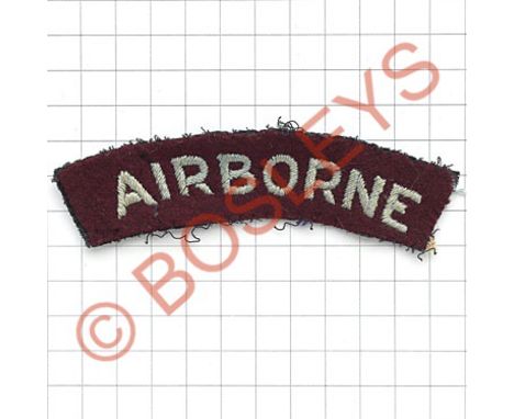 AIRBORNE WW2 cloth embroidered shoulder title.Slightly curved light blue sans-serif letters embroidered on maroon felt.   Rem