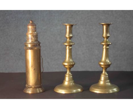 A pair of early 20th century brass candlesticks along with a portable brass candlestick lantern with pierced design. H.28 Dia