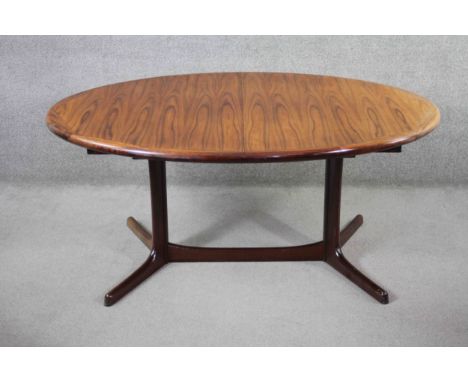 A vintage Danish dining table by Dyrland with two extra leaves and maker's label to the underside. H.75 W.65 D.115cm.