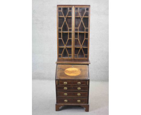 A late 19th century narrow mahogany and satinwood inlaid Georgian style two section bureau bookcase with astragal glazed uppe