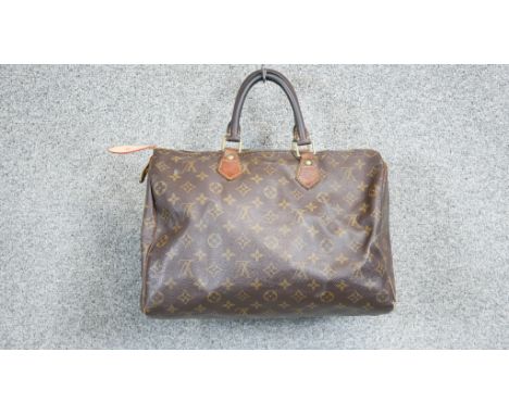 A vintage Louis Vuitton monogram Speedy 30 handbag, the maker's monogram coated canvas with smooth leather trim, double rolle