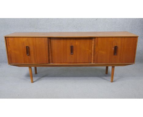 A mid century vintage teak sideboard on circular section supports. H.73 W.180 D.43cm 