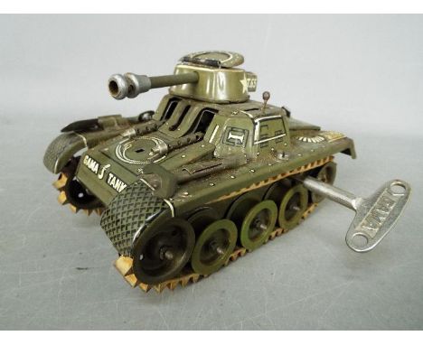 Gama - A vintage tinplate clockwork 'T65' Tank by Gama. The tank is green is complete with key, and measures approximately 16