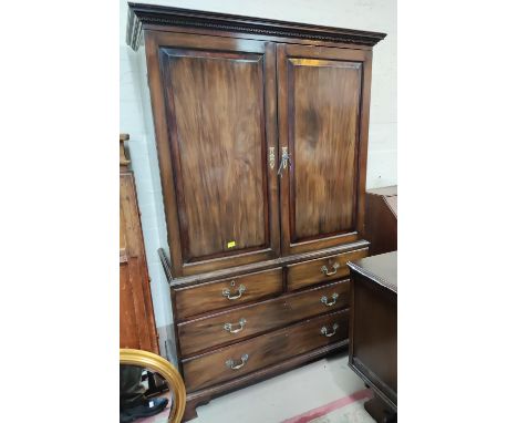 A Georgian mahogany press cupboard, the upper section enclosed by 2 doors, 2 long and 2 short drawers under, on bracket feet&