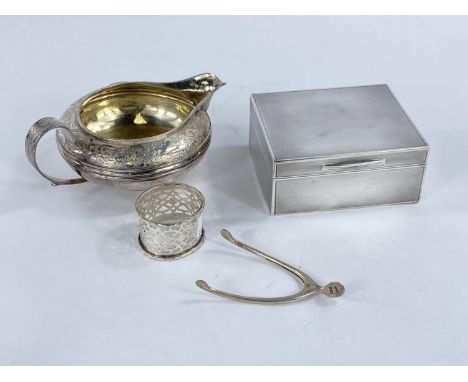 A hallmarked silver engine turned cigarette box, London 1918; an oriental white metal sauce boat; a pair of wisbone tongs; a 