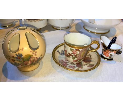 A Royal Worcester cup and saucer with gilt highlights and floral decoration; a similar pierced vase with floral decoration No