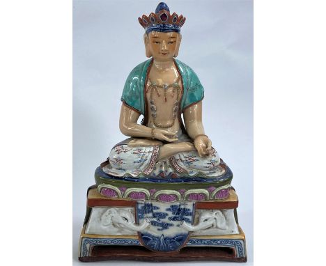 A Chinese ceramic figure of a Buddha in seated lotus position with hole to back possibly for wall hanging, ht. 19cm.&nbsp;&nb