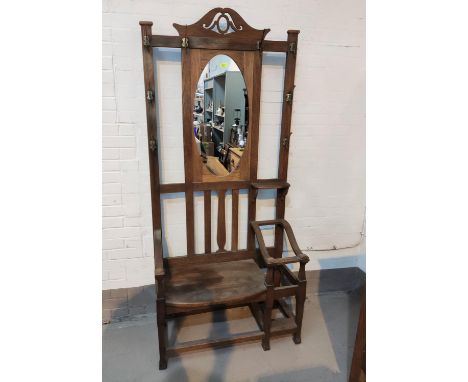 An Arts &amp; Crafts hall stand with mirror back, seat and 2 stick stands 