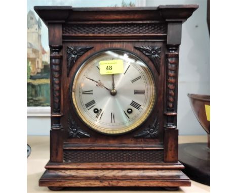 An architectural oak cased striking mantel clock 