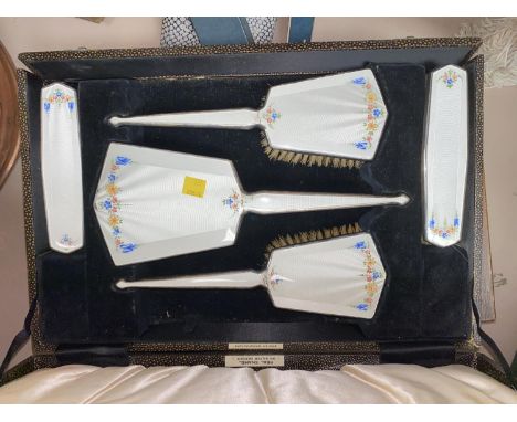 A raised silver on copper dressing table set with floral enamel backs and boxed and loose cutlery 