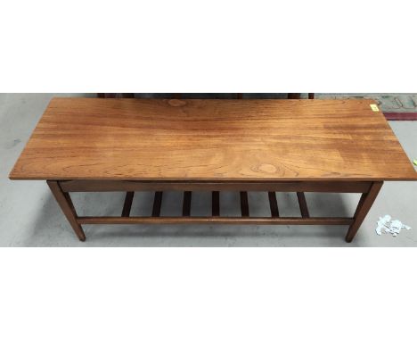 A mid 20th century long teak coffee table with ladder shelf under length 122cm 