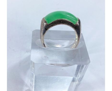 A white metal dress ring set with rounded oblong jade coloured stone, stamped '925' 5.66gms size O/P 