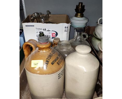 An opaque glass oil lamp, a selection of stoneware bottles, glass bottles etc 