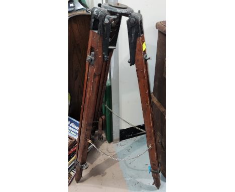 A vintage stained wood tripod stand with rise and fall legs 