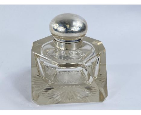 A large slice cut glass inkwell with hinged white metal lid, 13cm width 