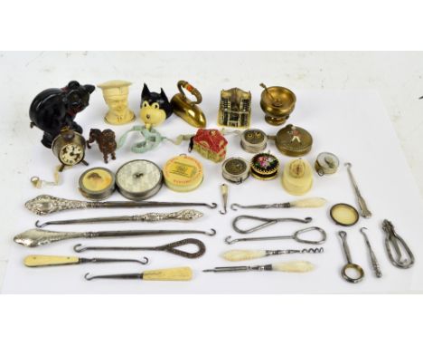 A group of novelty base metal and plastic tape measures including iron, poodle, Felix the Cat, cathedral, Johnny Walker adver