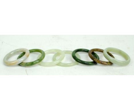 A group of Chinese jade and jadeite bangles in various shades of green (7).