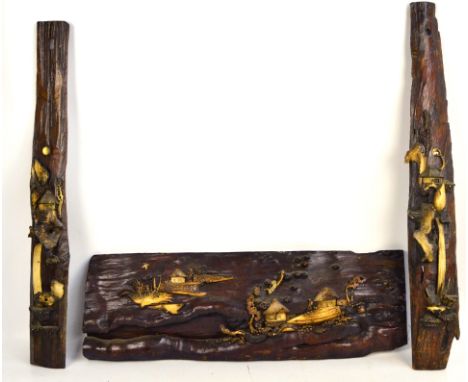 A pair of late 19th/early 20th century Japanese door/post wooden panels decorated in relief with bone and antlers depicting a