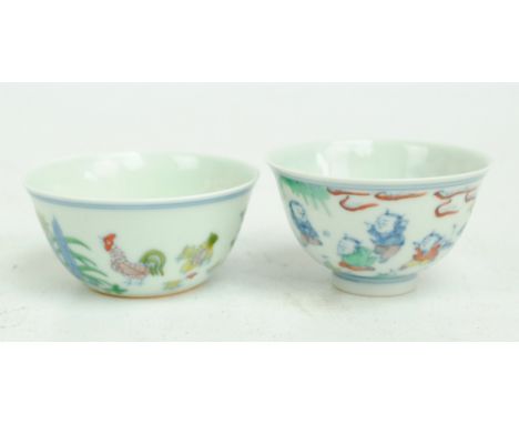 A Chinese Ducai porcelain tea cup, painted in underglaze blue and overglaze enamels with garden scene of boys playing, diamet